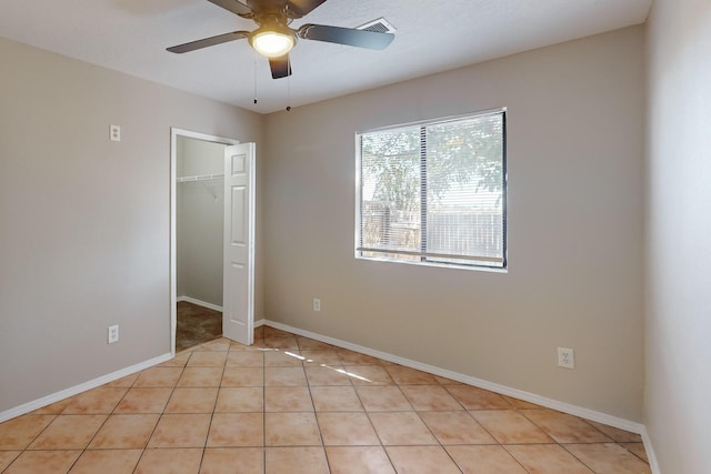 unfurnished bedroom featuring a closet, light tile patterned floors, and ceiling fan