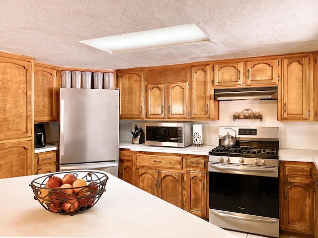 kitchen with stainless steel appliances and a textured ceiling