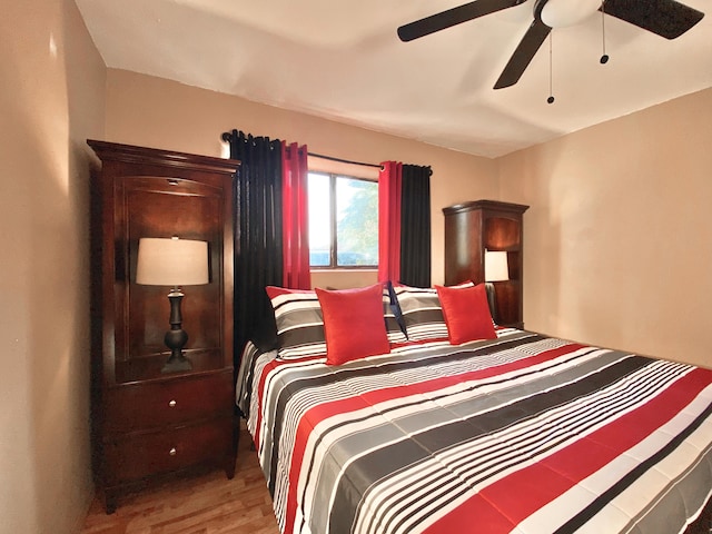 bedroom with light hardwood / wood-style flooring and ceiling fan