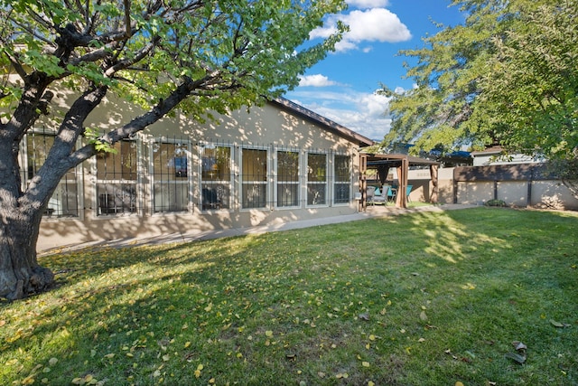 rear view of property with a yard