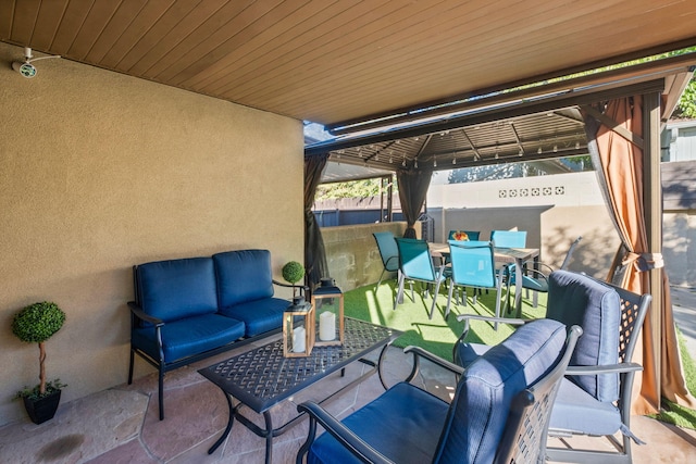 view of patio with outdoor lounge area and a gazebo