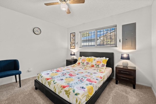 carpeted bedroom featuring electric panel, ceiling fan, and a textured ceiling