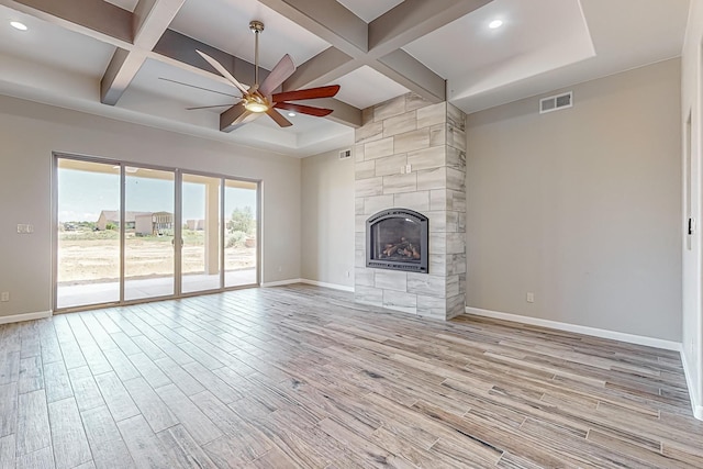 unfurnished living room with a fireplace, light hardwood / wood-style flooring, ceiling fan, and coffered ceiling