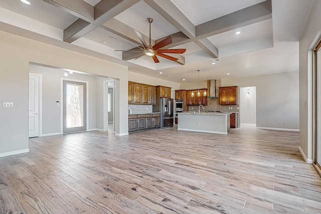 unfurnished living room featuring light hardwood / wood-style floors, ceiling fan, beam ceiling, and coffered ceiling