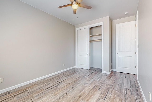 unfurnished bedroom featuring a closet, light hardwood / wood-style floors, and ceiling fan