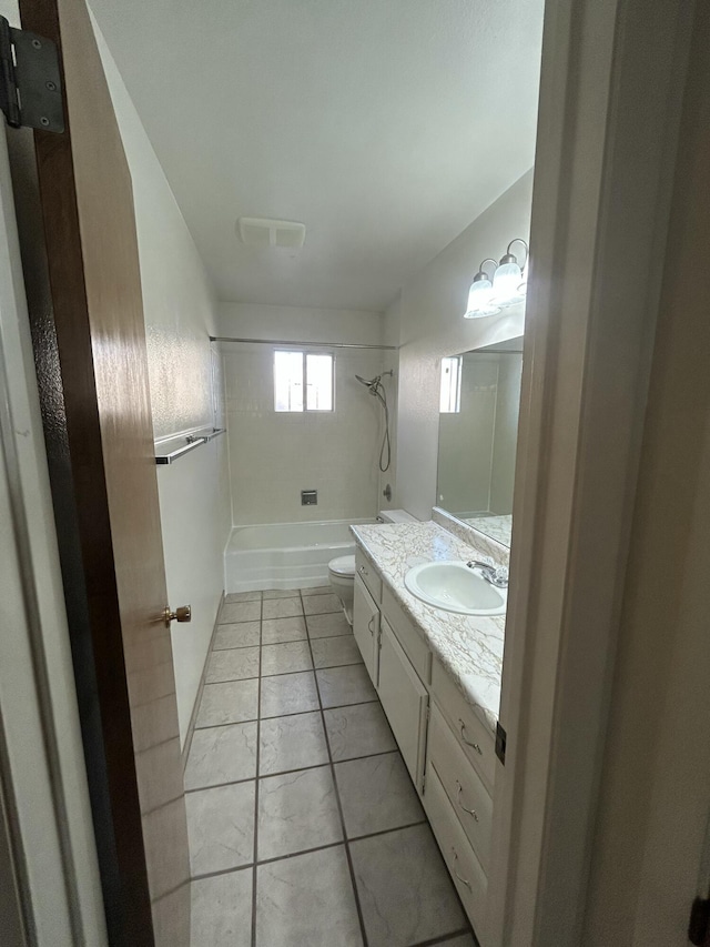 full bathroom featuring tile patterned flooring, vanity, toilet, and tiled shower / bath