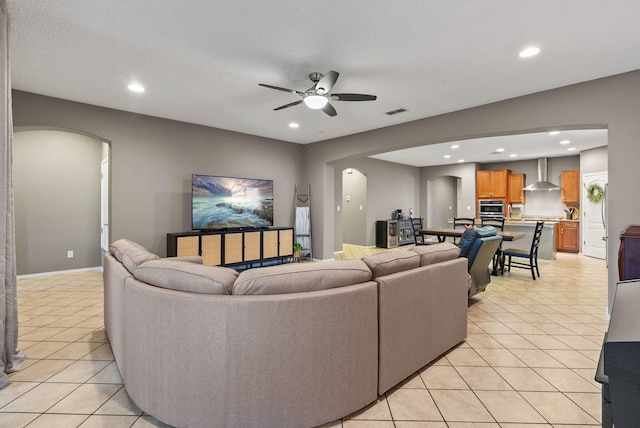 tiled living room with ceiling fan