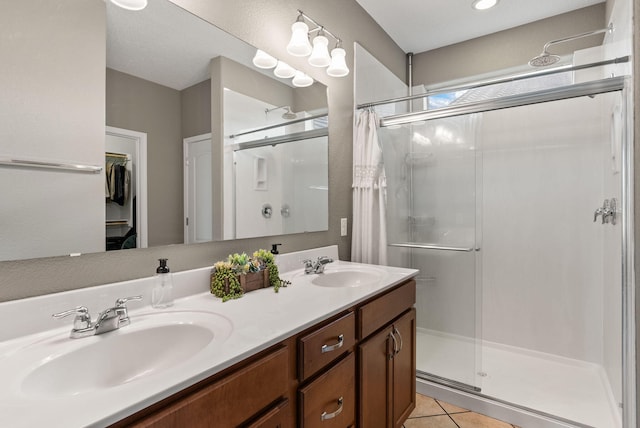 bathroom featuring vanity, tile patterned flooring, and a shower with door