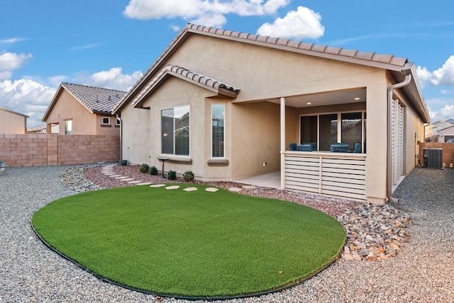 rear view of property with central air condition unit and a patio