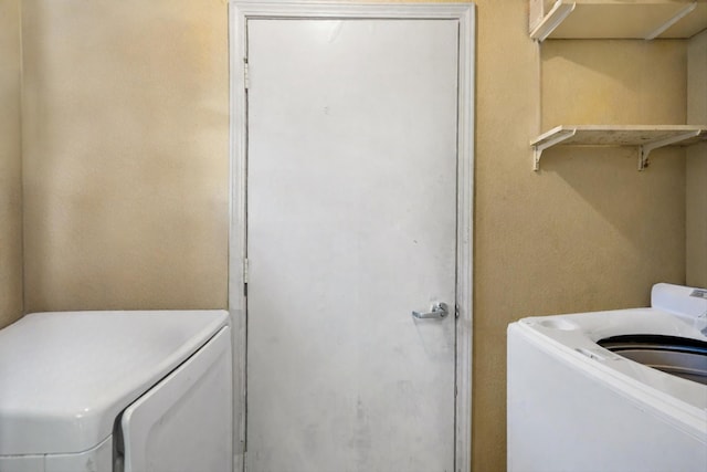 laundry room featuring washing machine and clothes dryer