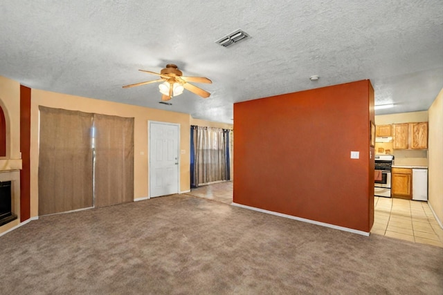 unfurnished living room featuring a textured ceiling, light carpet, and ceiling fan