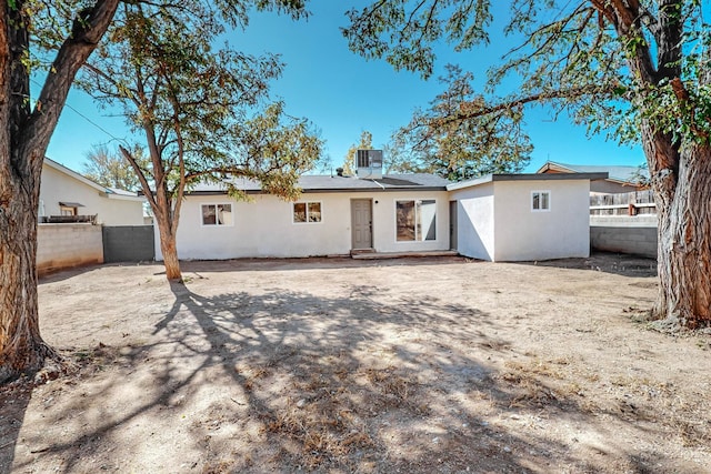 back of property with cooling unit