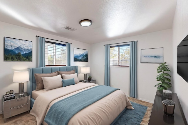 bedroom with carpet flooring and a textured ceiling