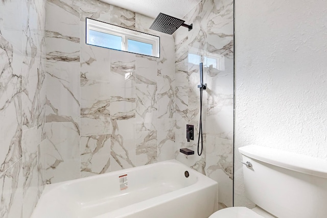 bathroom with tiled shower / bath combo and toilet