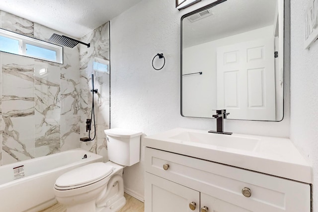 full bathroom featuring vanity, a textured ceiling, toilet, and tiled shower / bath