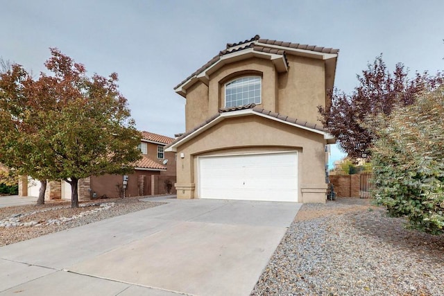 mediterranean / spanish-style home featuring a garage