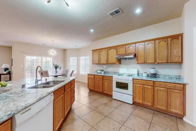 kitchen featuring white appliances, an inviting chandelier, sink, hanging light fixtures, and light tile patterned flooring