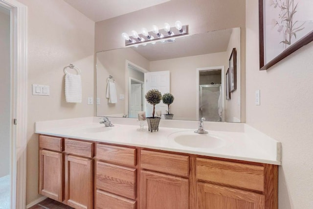 bathroom featuring vanity and a shower with shower door