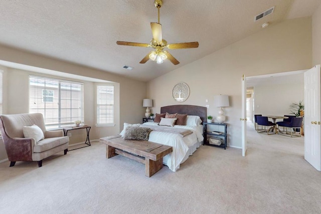 bedroom featuring a textured ceiling, ceiling fan, light colored carpet, and lofted ceiling