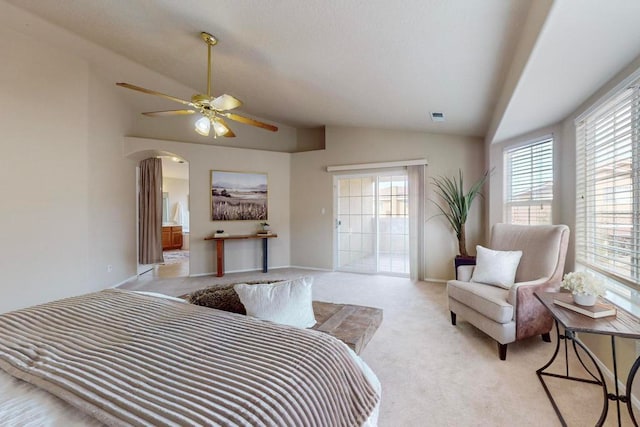 carpeted bedroom with ceiling fan and vaulted ceiling