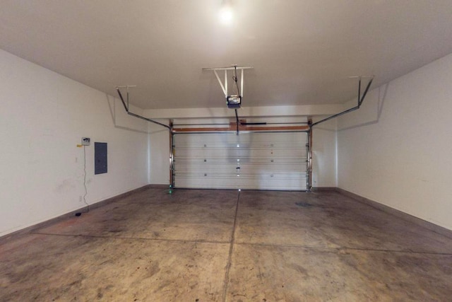 garage featuring electric panel and a garage door opener