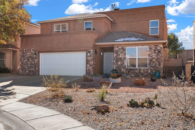 pueblo-style home featuring a garage