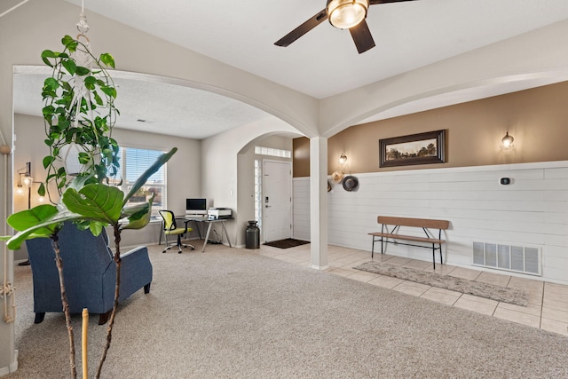 interior space with ceiling fan