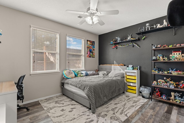 bedroom with ceiling fan and hardwood / wood-style floors