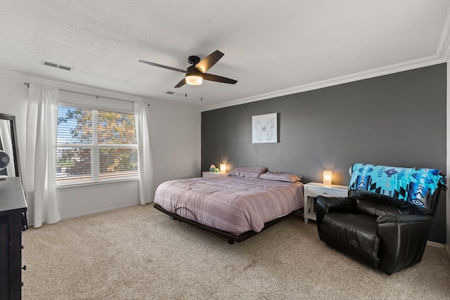 carpeted bedroom with ornamental molding, ceiling fan, and a textured ceiling