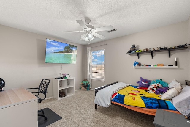 bedroom featuring ceiling fan, a textured ceiling, and carpet