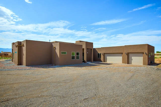 southwest-style home with a garage