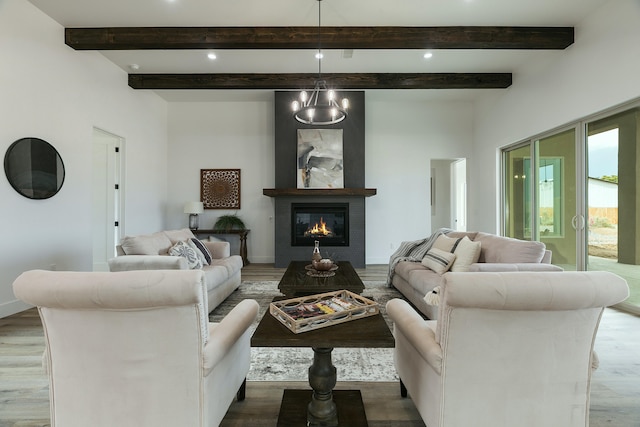 living room with a chandelier, beam ceiling, and light hardwood / wood-style flooring