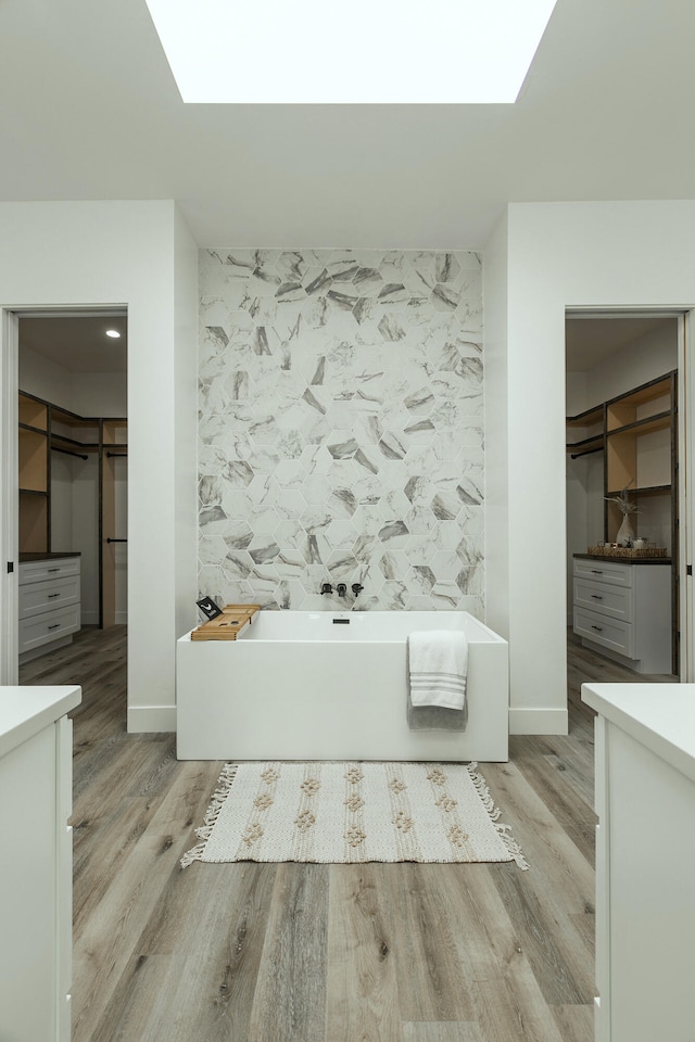 bathroom featuring a tub, vanity, and hardwood / wood-style flooring