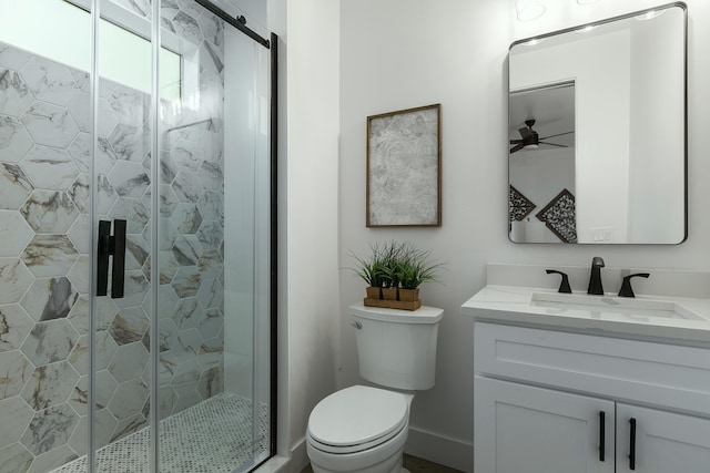 bathroom with ceiling fan, a shower with door, vanity, and toilet