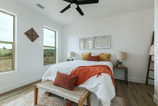 bedroom featuring ceiling fan and dark wood-type flooring