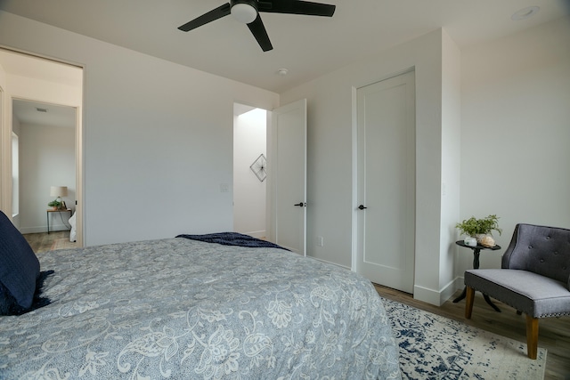 bedroom with ceiling fan and hardwood / wood-style flooring