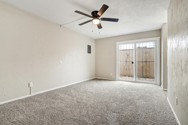 carpeted empty room with ceiling fan and a textured ceiling