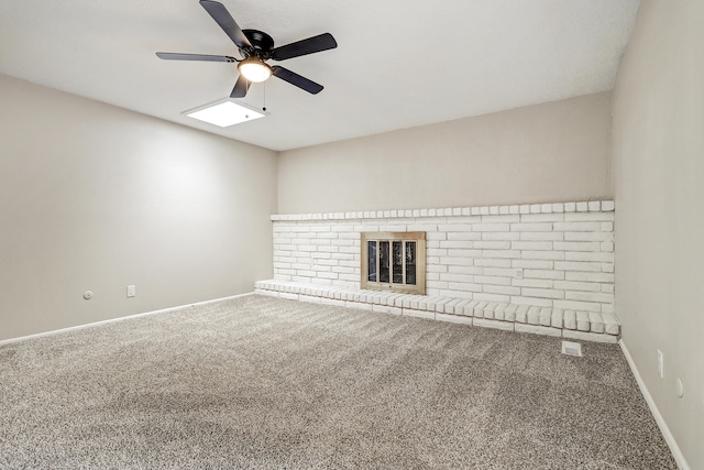 unfurnished living room featuring carpet floors, a brick fireplace, and ceiling fan