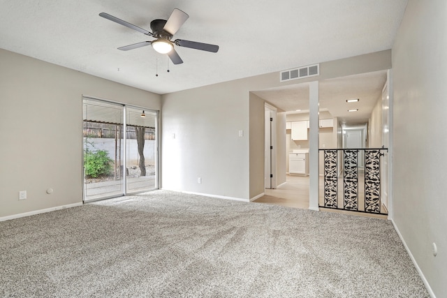 carpeted empty room featuring ceiling fan