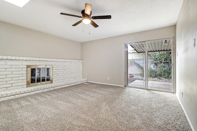 unfurnished living room with ceiling fan, a fireplace, and a textured ceiling