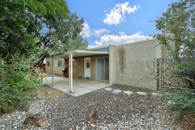 back of property featuring a patio area