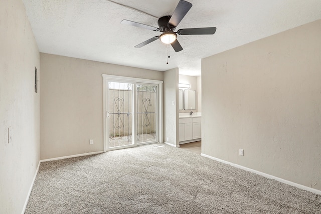 carpeted empty room with a textured ceiling and ceiling fan