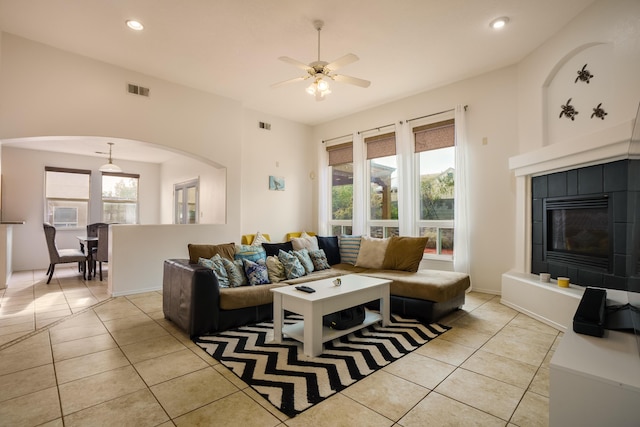 living room with ceiling fan, light tile patterned floors, and a wealth of natural light