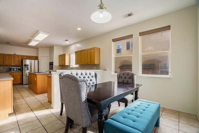 tiled dining space featuring sink