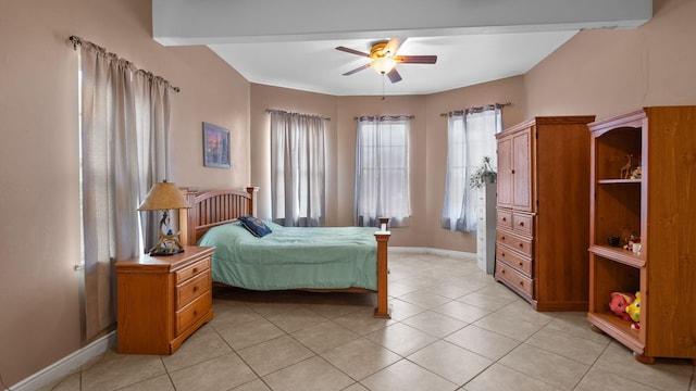 tiled bedroom featuring beamed ceiling and ceiling fan