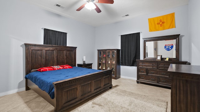 tiled bedroom featuring ceiling fan