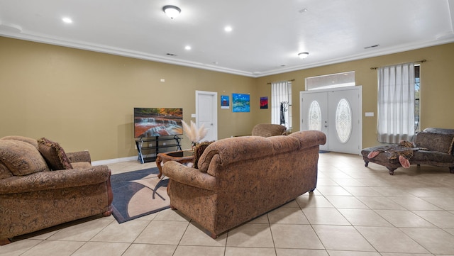 living room featuring light tile patterned flooring, french doors, and crown molding