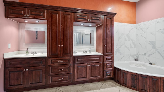 bathroom featuring vanity, tile patterned floors, and a tub