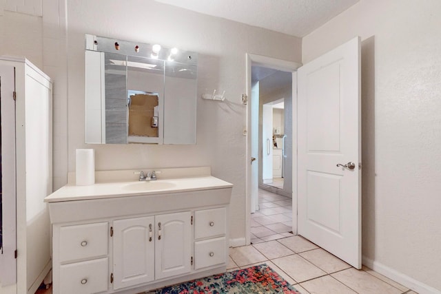 bathroom featuring vanity, a textured ceiling, and tile patterned floors