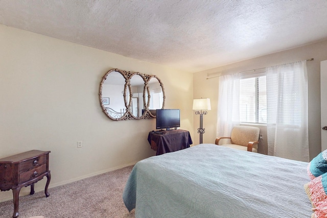 carpeted bedroom featuring a textured ceiling